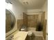 Bathroom featuring neutral tile and finishes, a bathtub/shower combination, and a large mirror at 4231 N 69Th Ln # 1325, Phoenix, AZ 85033