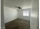 Neutral bedroom with a ceiling fan, cozy carpeting, and a bright window for natural light at 4231 N 69Th Ln # 1325, Phoenix, AZ 85033