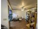 Bright dining area with hardwood floors, ceiling fan, dining table, and access to the kitchen at 4231 N 69Th Ln # 1325, Phoenix, AZ 85033