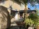 Charming front entrance with rustic stucco exterior, potted plants, security gate, and desert landscaping at 4231 N 69Th Ln # 1325, Phoenix, AZ 85033