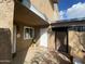 Welcoming front entrance with tiled patio, security gate, decorative welcome sign, and desert landscaping at 4231 N 69Th Ln # 1325, Phoenix, AZ 85033