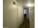 Well-lit hallway with a closet and view into another room at 4231 N 69Th Ln # 1325, Phoenix, AZ 85033
