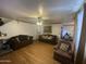 Cozy living room with hardwood floors, comfortable sofas, ceiling fan, and natural light at 4231 N 69Th Ln # 1325, Phoenix, AZ 85033
