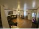 Spacious living room with hardwood floors, comfortable sofas, ceiling fan, and a view of the front door at 4231 N 69Th Ln # 1325, Phoenix, AZ 85033