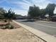 Street view of the neighborhood with sidewalks and mature trees at 4231 N 69Th Ln # 1325, Phoenix, AZ 85033