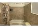 Shower-tub combo features neutral tile and a Halloween themed shower curtain at 4231 N 69Th Ln # 1325, Phoenix, AZ 85033