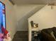 Carpeted staircase ascends from a living area with a side table at 4231 N 69Th Ln # 1325, Phoenix, AZ 85033
