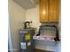 Practical utility room featuring a water heater, storage cabinet, and space for various household needs at 4231 N 69Th Ln # 1325, Phoenix, AZ 85033