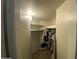 Spacious walk-in closet with built-in shelves and ample hanging space for organized storage at 4231 N 69Th Ln # 1325, Phoenix, AZ 85033