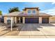 Charming two-story home with desert landscaping, tile roof, and a three-car garage at 4233 E Vista Dr, Phoenix, AZ 85032