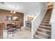 Dining area adjacent to kitchen with seating for four and stairway in view at 42424 N Gavilan Peak Pkwy # 25102, Anthem, AZ 85086