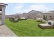 This backyard has a green lawn, patio furniture, and an umbrella at 4271 W Josephine St, San Tan Valley, AZ 85144