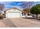 Lovely front exterior showcasing a garage, desert landscaping and a blue sky at 4558 E Rock Wren Rd, Phoenix, AZ 85044