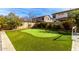 Beautiful backyard with artificial turf, a putting green, and lush landscaping offering outdoor recreation at 4727 S Watauga Dr, Gilbert, AZ 85297
