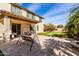 Spacious backyard featuring a covered patio, artificial grass area, and a charming swing set for leisure at 4727 S Watauga Dr, Gilbert, AZ 85297