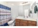 Bathroom featuring a vanity with colorful hardware and a shower with a marine-themed curtain at 4727 S Watauga Dr, Gilbert, AZ 85297