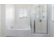 Bright bathroom featuring a separate shower and soaking tub, with a window providing natural light at 4727 S Watauga Dr, Gilbert, AZ 85297