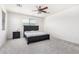 Bedroom with cozy carpeting, ceiling fan, ample natural light, and a comfortable bed at 4727 S Watauga Dr, Gilbert, AZ 85297