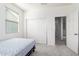 Bright bedroom featuring carpeted floors, a bed, and a closet with sliding doors at 4727 S Watauga Dr, Gilbert, AZ 85297