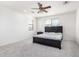 Bedroom featuring neutral carpet, large bed, ceiling fan and windows to let in natural light at 4727 S Watauga Dr, Gilbert, AZ 85297