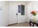 Bright entryway featuring a white front door and a decorative floral arrangement at 4727 S Watauga Dr, Gilbert, AZ 85297