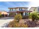 Two-story home with a two-car garage and a beautiful desert-landscaped front yard at 4727 S Watauga Dr, Gilbert, AZ 85297