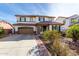 Charming two-story home with a desert landscape, two-car garage, and tile roof at 4727 S Watauga Dr, Gilbert, AZ 85297