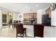 Stylish kitchen features a breakfast bar, tile flooring, stainless steel appliances, and easy access to the outdoor patio at 4727 S Watauga Dr, Gilbert, AZ 85297