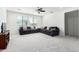 Spacious living room with plush carpeting, ceiling fan, and large windows for ample natural light at 4727 S Watauga Dr, Gilbert, AZ 85297