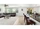Open-concept space with a dark sectional, bar seating, tile flooring, and natural light from sliding glass doors at 4727 S Watauga Dr, Gilbert, AZ 85297