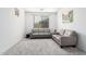 Bright living room featuring gray sofas, neutral carpeting, and a minimalist design at 4727 S Watauga Dr, Gilbert, AZ 85297
