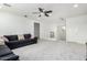 Upstairs loft featuring neutral carpeting, white walls, a ceiling fan, and staircase access at 4727 S Watauga Dr, Gilbert, AZ 85297