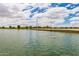 A wide shot of the community pond with a bridge in the background on a bright day at 4727 S Watauga Dr, Gilbert, AZ 85297