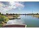 A picturesque aerial view of the community pond with a pier and mature landscaping at 4727 S Watauga Dr, Gilbert, AZ 85297