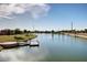 An aerial view of the community pond with a pier and mature landscaping on a sunny day at 4727 S Watauga Dr, Gilbert, AZ 85297