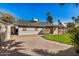 Rear exterior showcases the home's well-kept yard, covered patio, and ample parking with desert landscaping at 4813 W Milky Way, Chandler, AZ 85226