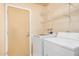 Laundry room featuring tile flooring, washer, dryer, and shelving at 4813 W Milky Way, Chandler, AZ 85226