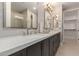 The bathroom boasts dual sinks, a large mirror, and access to a walk-in closet at 5250 E Deer Valley Dr # 246, Phoenix, AZ 85054