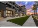 Luxurious exterior view of a modern building featuring a spacious patio and manicured lawn at 5250 E Deer Valley Dr # 246, Phoenix, AZ 85054