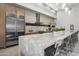 Large kitchen with stainless steel appliances, marble countertops, and bar stool seating at 5250 E Deer Valley Dr # 246, Phoenix, AZ 85054