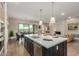 Kitchen island with white countertop overlooks dining and living areas with a fireplace feature at 5250 E Deer Valley Dr # 246, Phoenix, AZ 85054