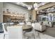 Open lobby with multiple seating areas, a modern kitchen, stylish lighting, and an elegant staircase at 5250 E Deer Valley Dr # 246, Phoenix, AZ 85054