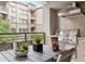 Outdoor kitchen features a stainless steel Coyote grill, vent hood, and outdoor dining set at 5250 E Deer Valley Dr # 246, Phoenix, AZ 85054