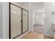 Bathroom showcasing a glass-enclosed shower with tiled walls and wood look floors at 5359 W Las Palmaritas Dr, Glendale, AZ 85302