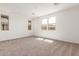 Expansive bedroom with neutral carpeting, multiple windows offering plenty of natural light, and a serene atmosphere at 5359 W Las Palmaritas Dr, Glendale, AZ 85302