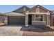 Charming single-story home with a gray color scheme, complemented by a well-manicured front yard at 5359 W Las Palmaritas Dr, Glendale, AZ 85302