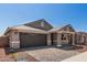 A well-maintained home with a two-car garage, stone details, and a tiled roof at 5359 W Las Palmaritas Dr, Glendale, AZ 85302