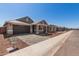 A modern home showcasing a stone accent exterior, two-car garage and tiled roof at 5359 W Las Palmaritas Dr, Glendale, AZ 85302