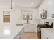Well-lit kitchen with white cabinetry, stainless steel appliances, and a convenient center island for meal preparation at 5359 W Las Palmaritas Dr, Glendale, AZ 85302