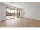 Sunlit living area featuring wood-look flooring and large sliding glass doors, seamlessly connecting indoor and outdoor spaces at 5359 W Las Palmaritas Dr, Glendale, AZ 85302